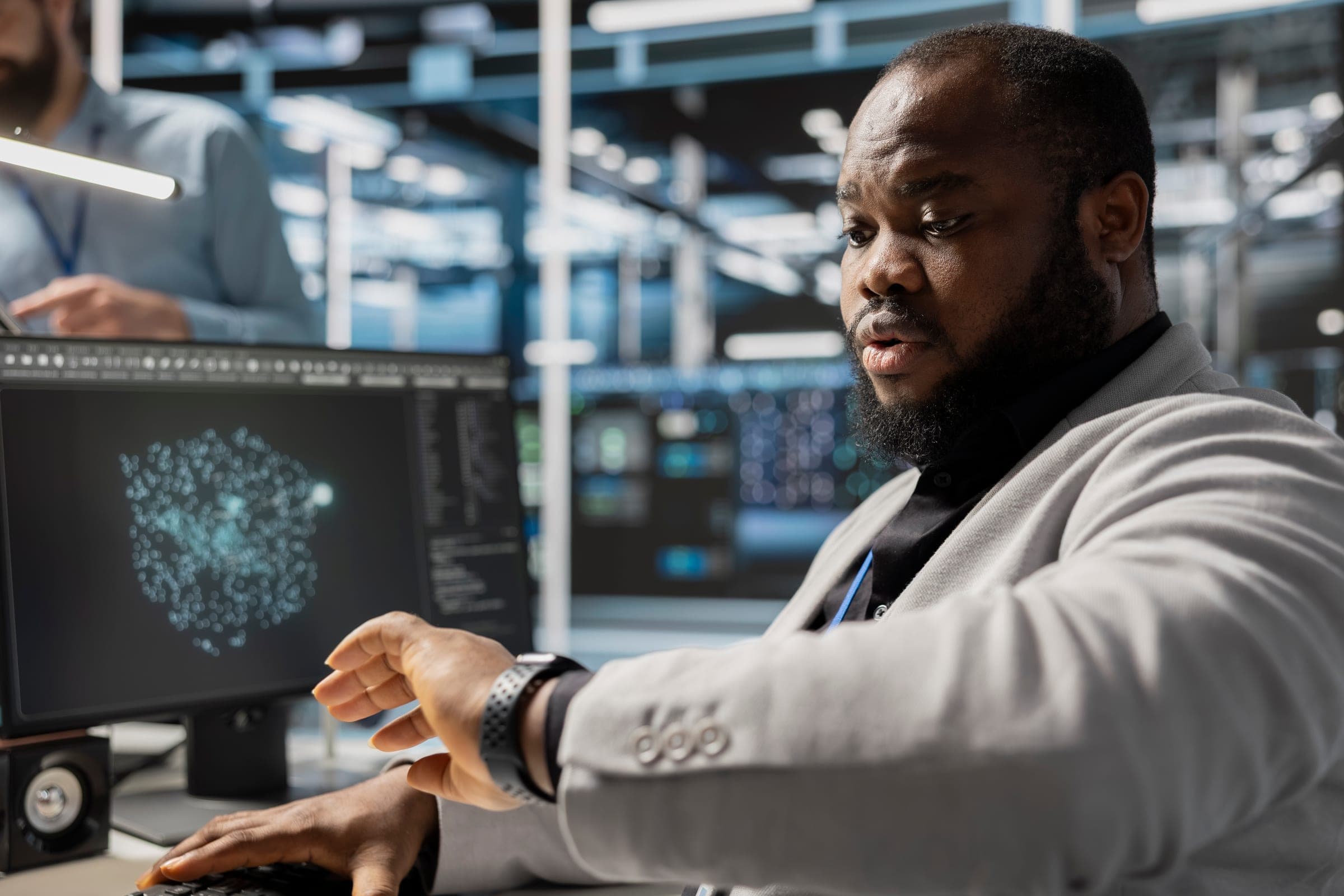 Administrator working at a screen inside a data center.