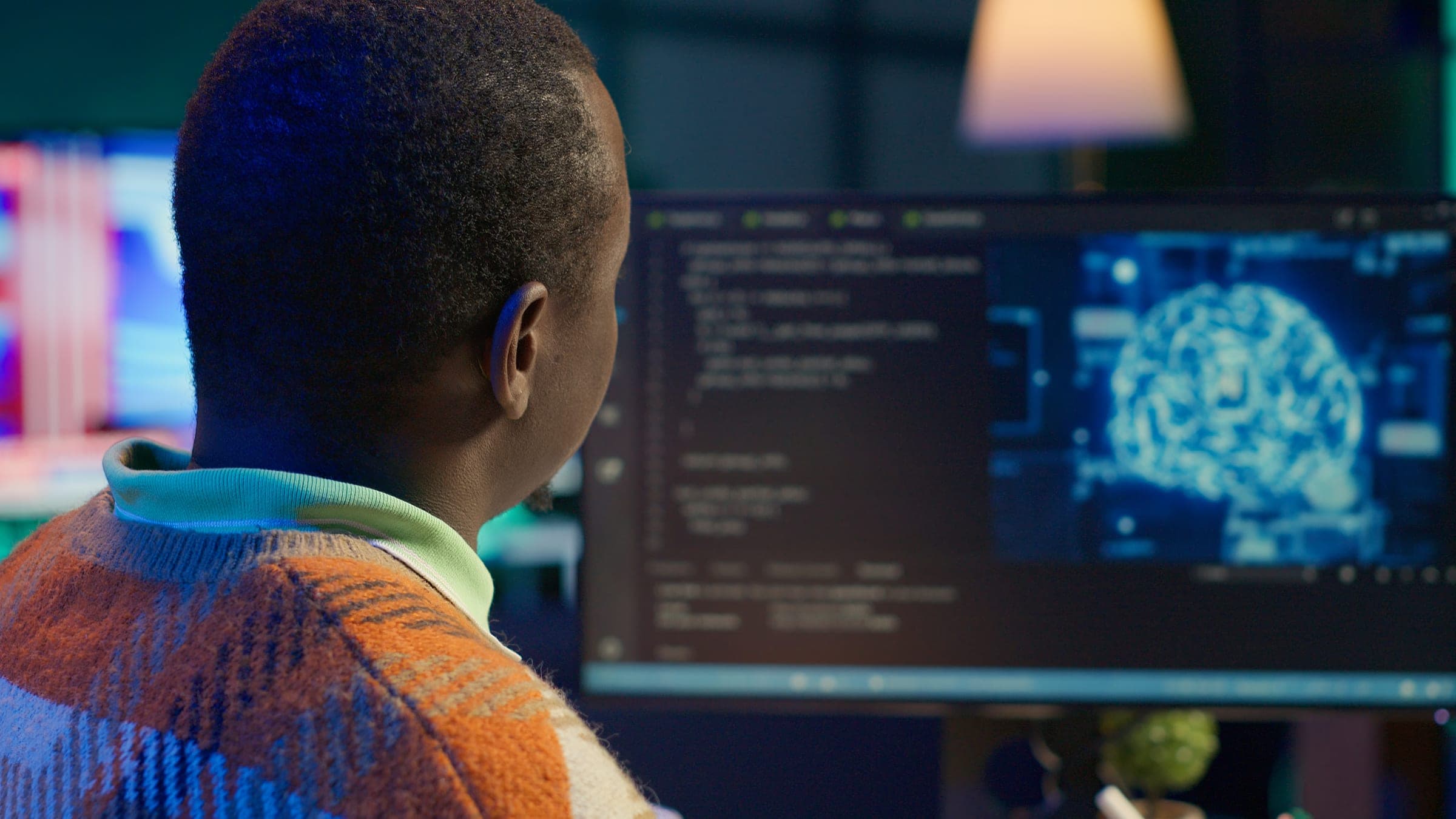Software engineer writing code at a workstation.